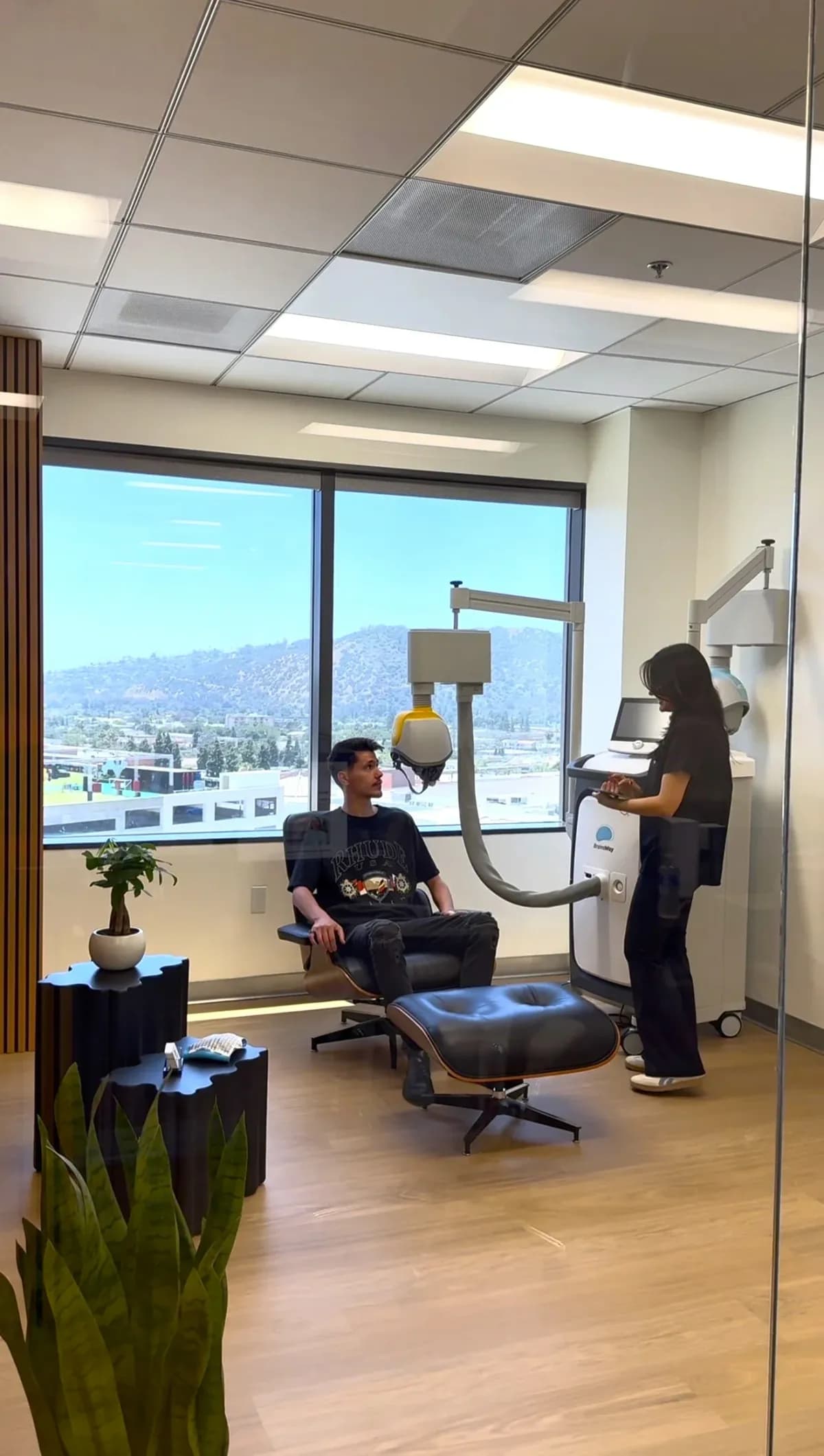Clinician monitoring a patient during BrainsWay Deep TMS treatment